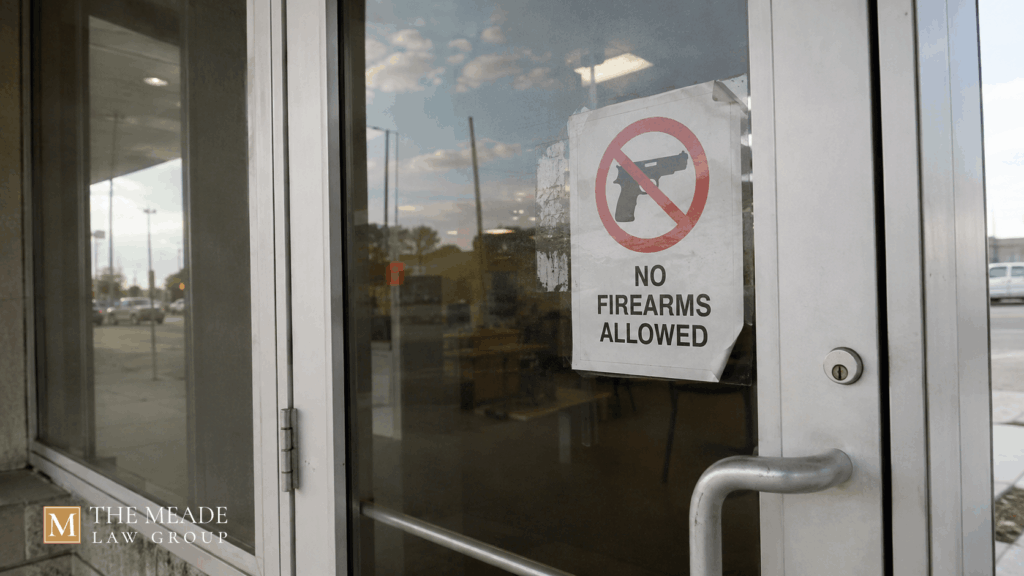 "No Firearms Allowed" sign posted on a glass entrance door in Ohio