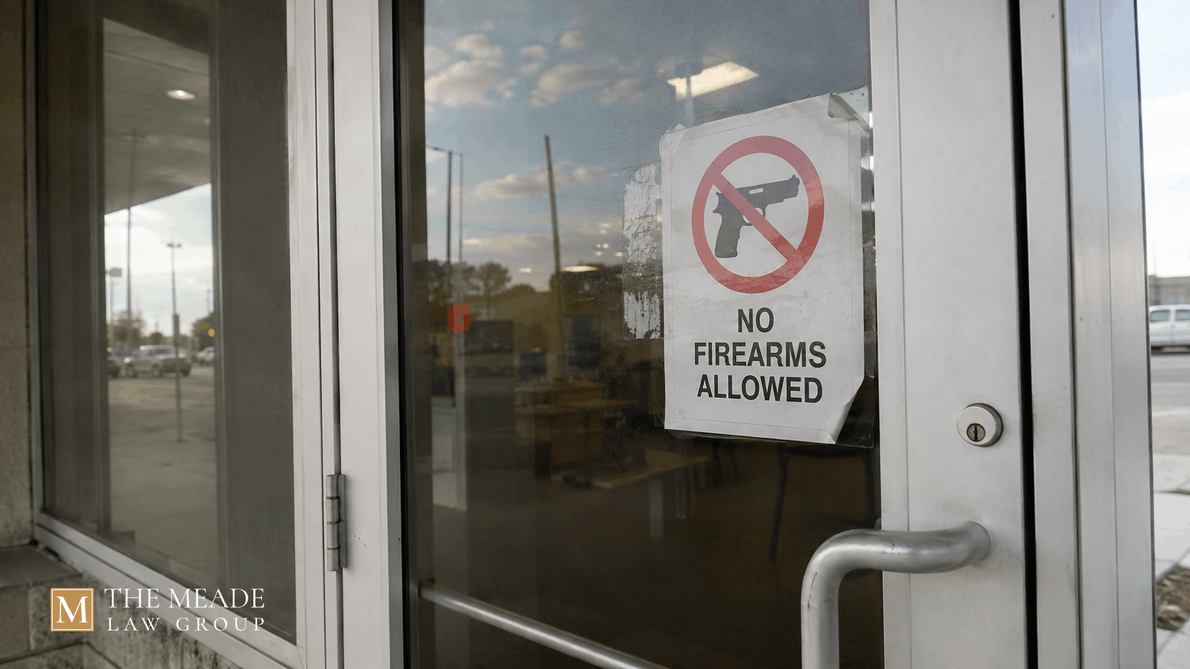 "No Firearms Allowed" sign posted on a glass entrance door in Ohio