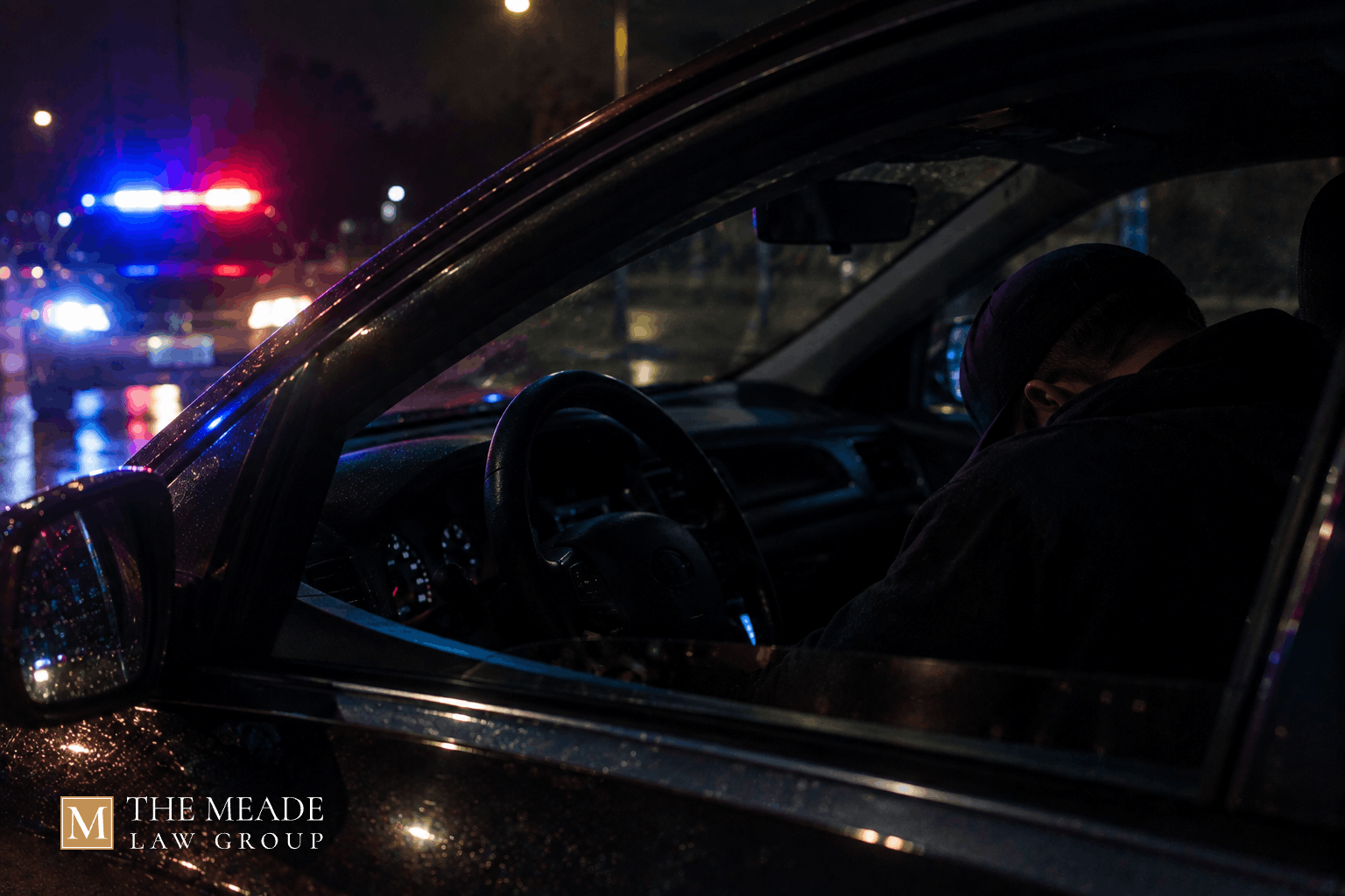 Person asleep in the driver's seat of a parked car at night, illustrating an Ohio physical control charge.