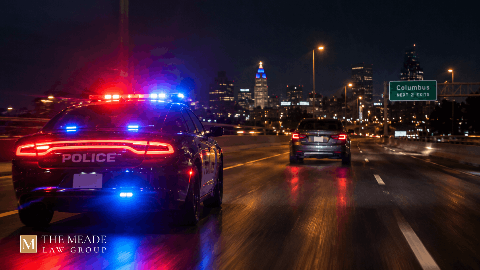 Police cruiser with flashing lights pursuing a car at night on an Ohio road, illustrating a failure to comply charge.